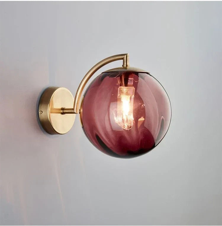 Sleek Wall Light with Glass Globe & Elegant Brass Touches