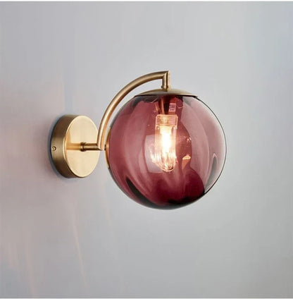Sleek Wall Light with Glass Globe & Elegant Brass Touches