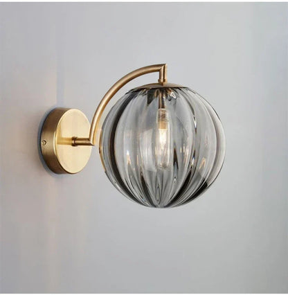Sleek Wall Light with Glass Globe & Elegant Brass Touches