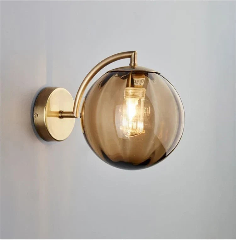 Sleek Wall Light with Glass Globe & Elegant Brass Touches