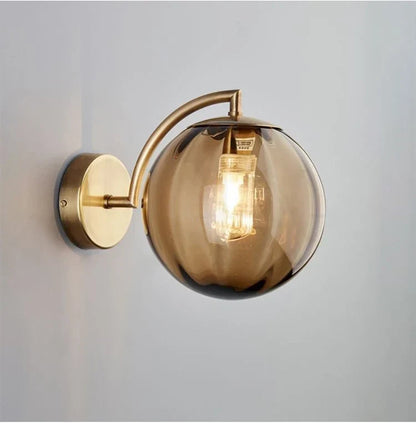 Sleek Wall Light with Glass Globe & Elegant Brass Touches