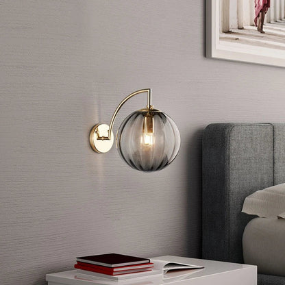 Sleek Wall Light with Glass Globe & Elegant Brass Touches
