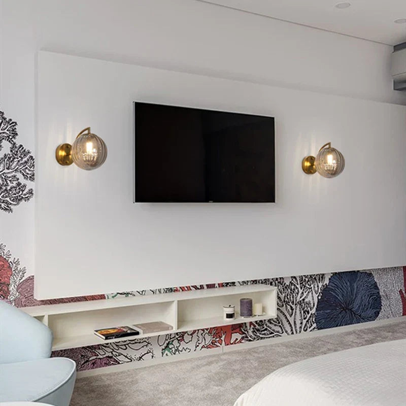 Sleek Wall Light with Glass Globe & Elegant Brass Touches